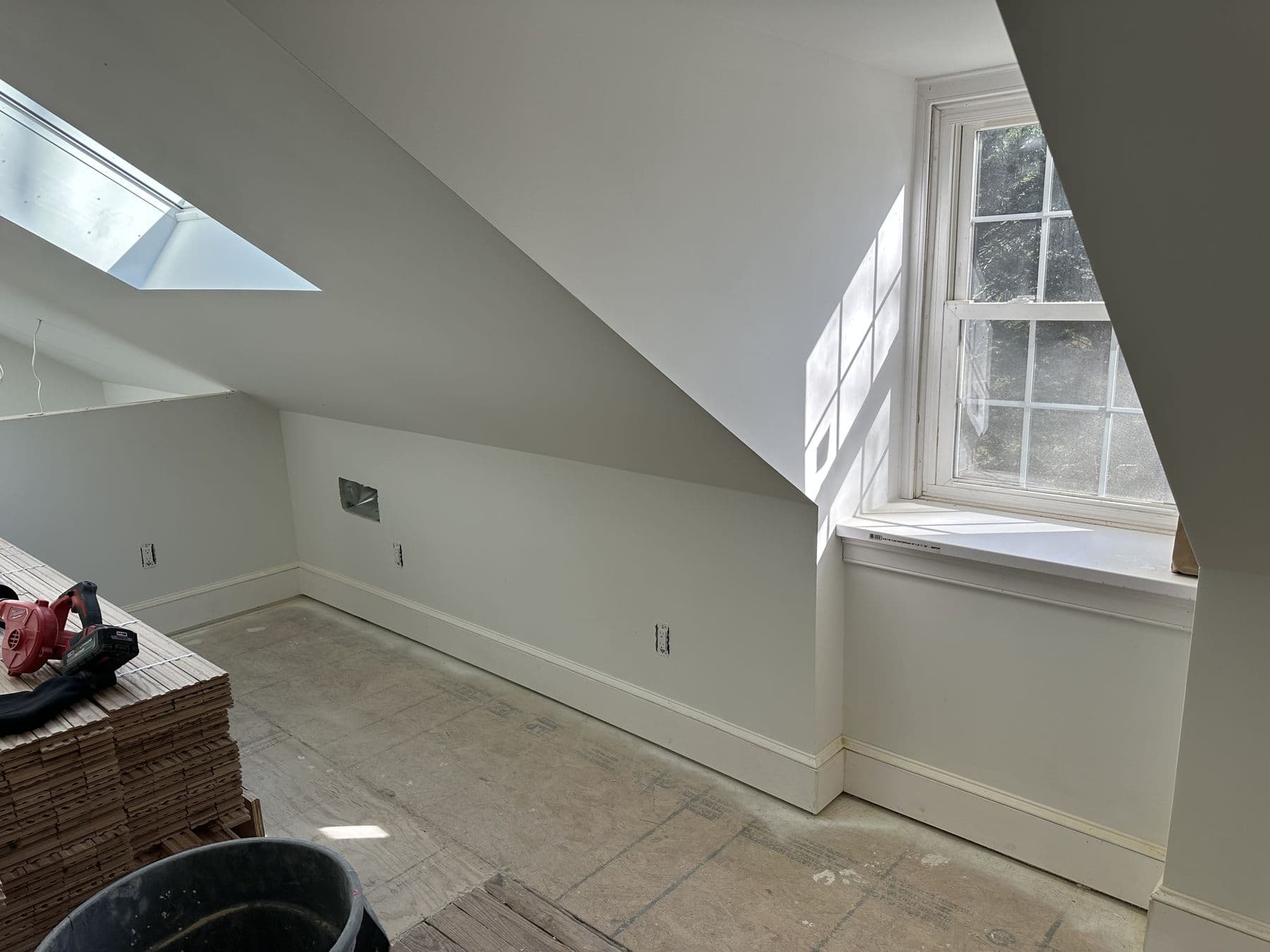 Attic room with a skylight, knee wall and new baseboard