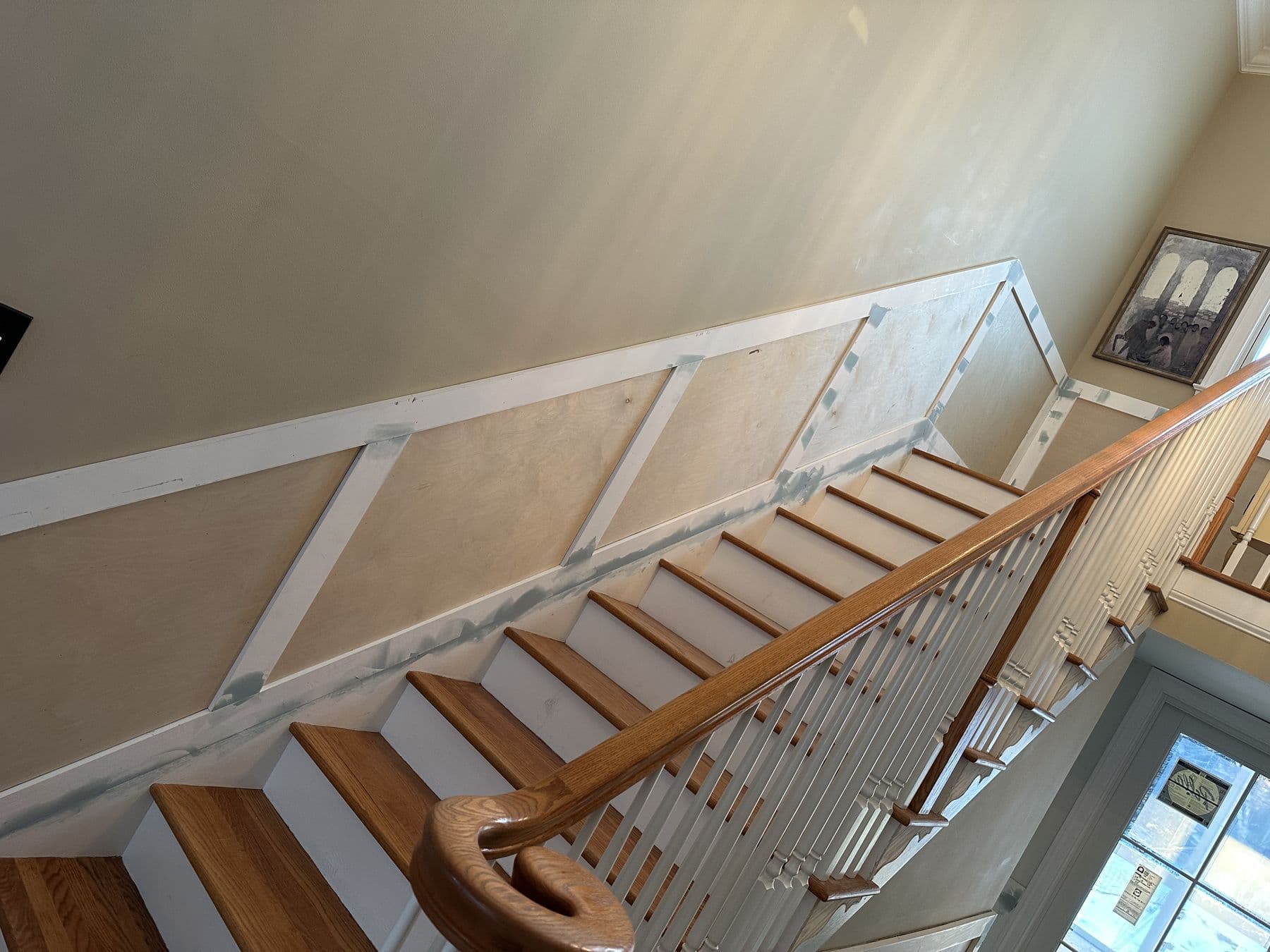 Staircase with new picture-frame wainscot following the stair angle
