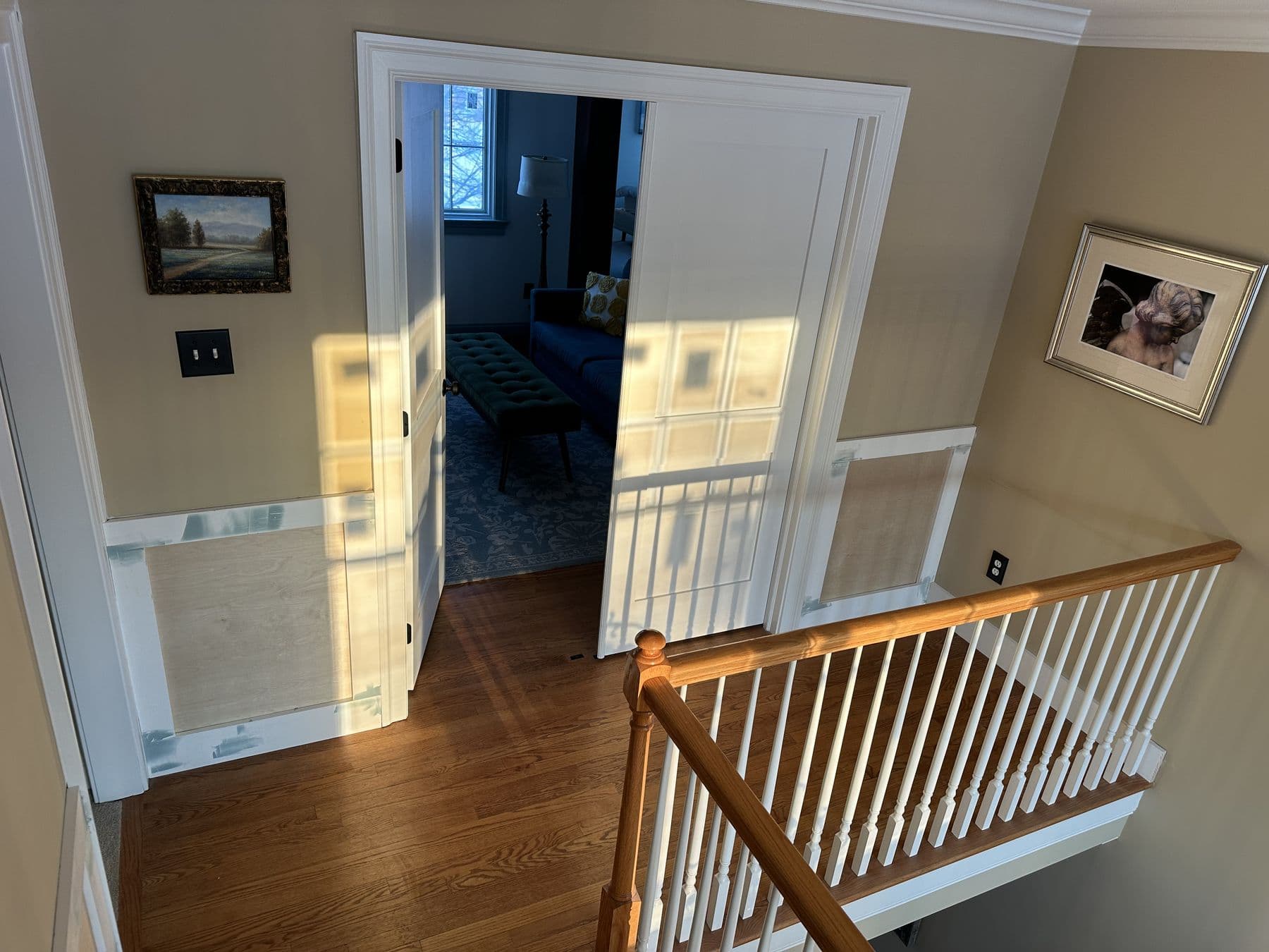 Upper landing with wainscot, railing and a doorway