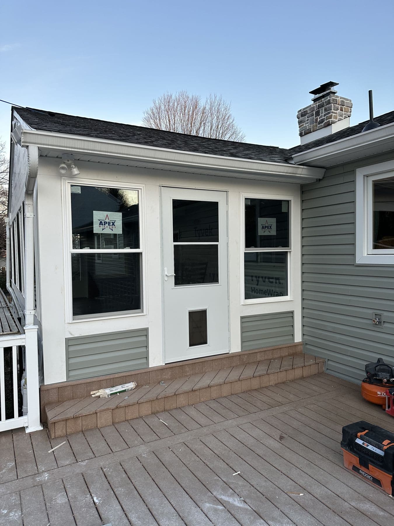 Finished sunroom with new windows, door and trim on the deck