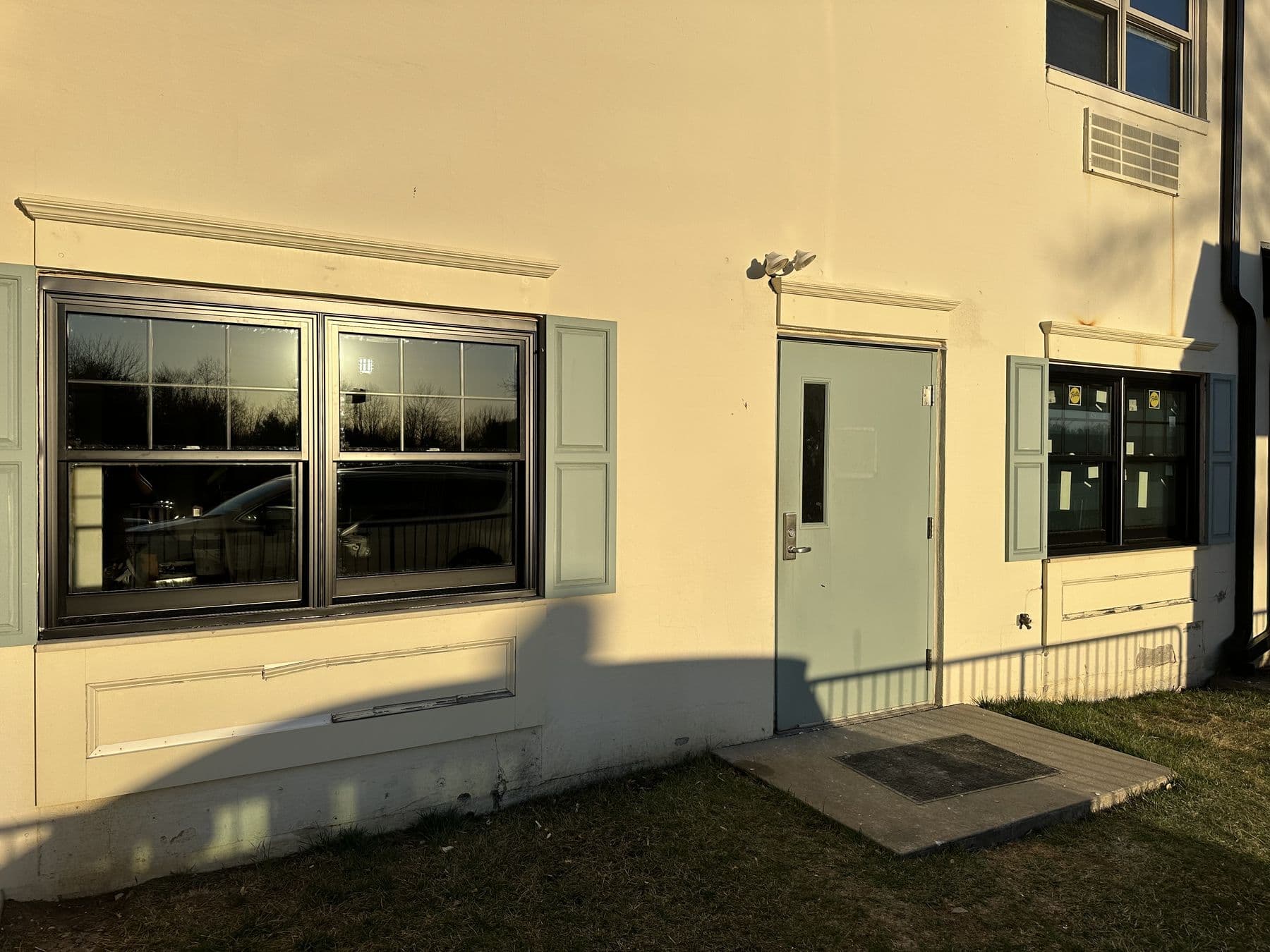 Row of new windows and a door along the office building wall