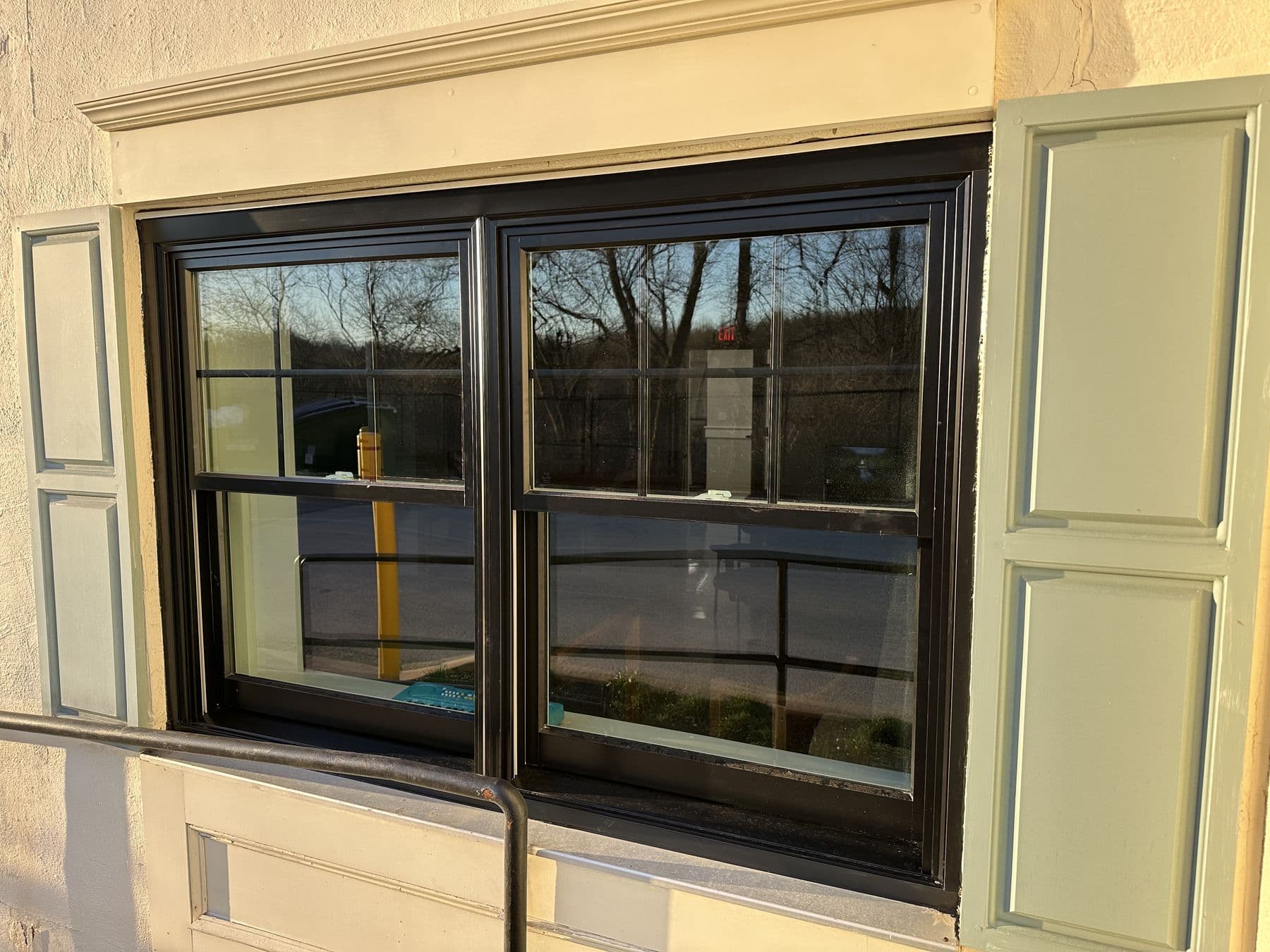 New black window with shutters seen at an angle