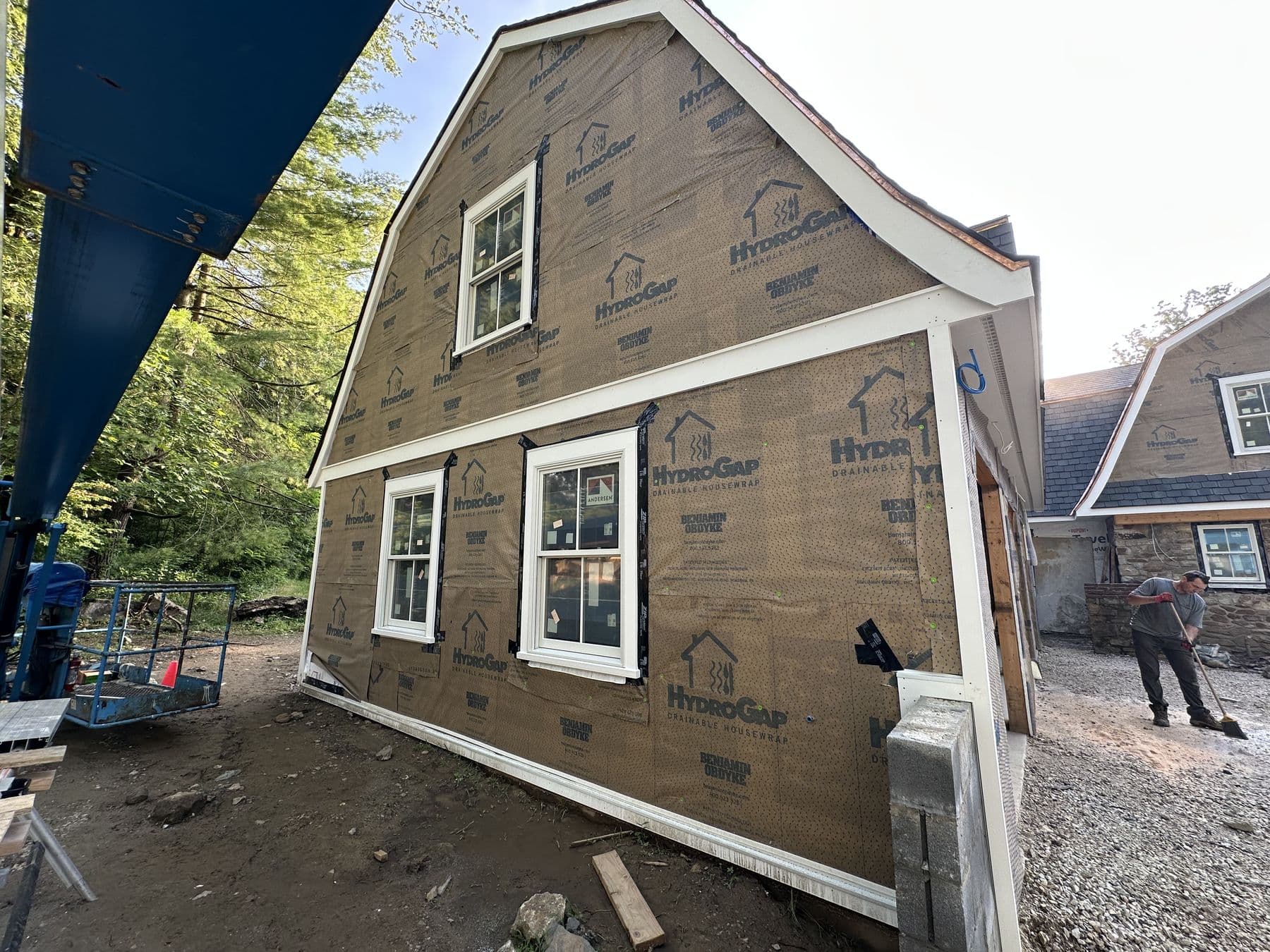 Gambrel gable wall wrapped in housewrap with the window trim installed