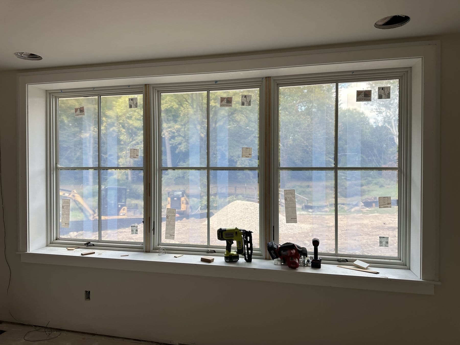 Triple window unit with new interior trim and a deep stool
