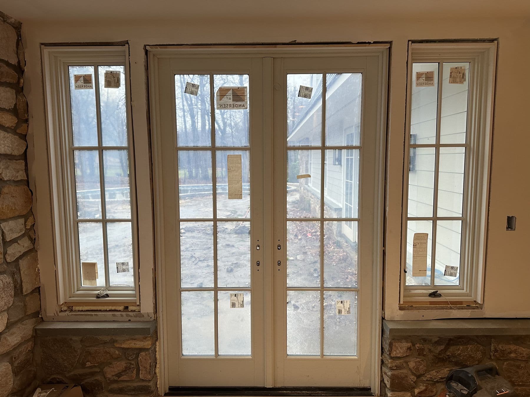 Pair of French doors with sidelights in a fieldstone wall