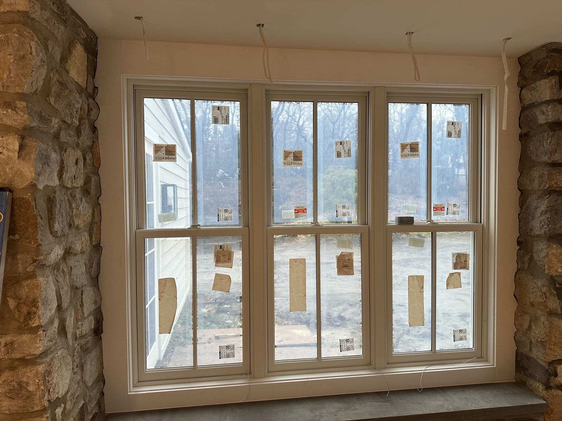 Triple window in a stone wall with new interior trim