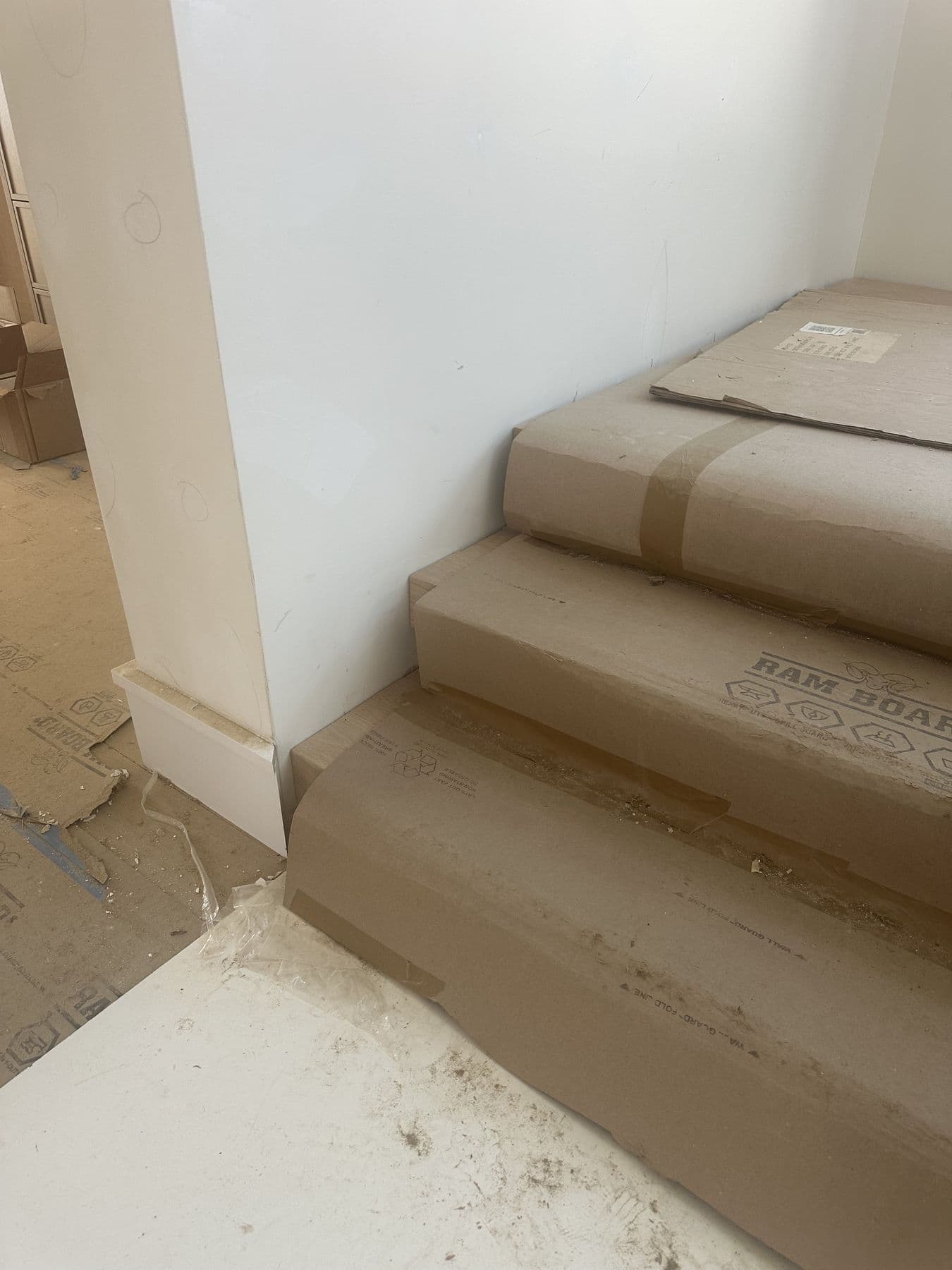 New stair treads and risers under protective paper in the addition