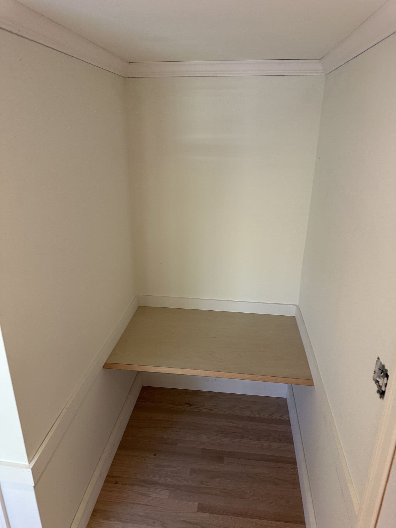 Paneled nook with a built-in shelf and white wainscot
