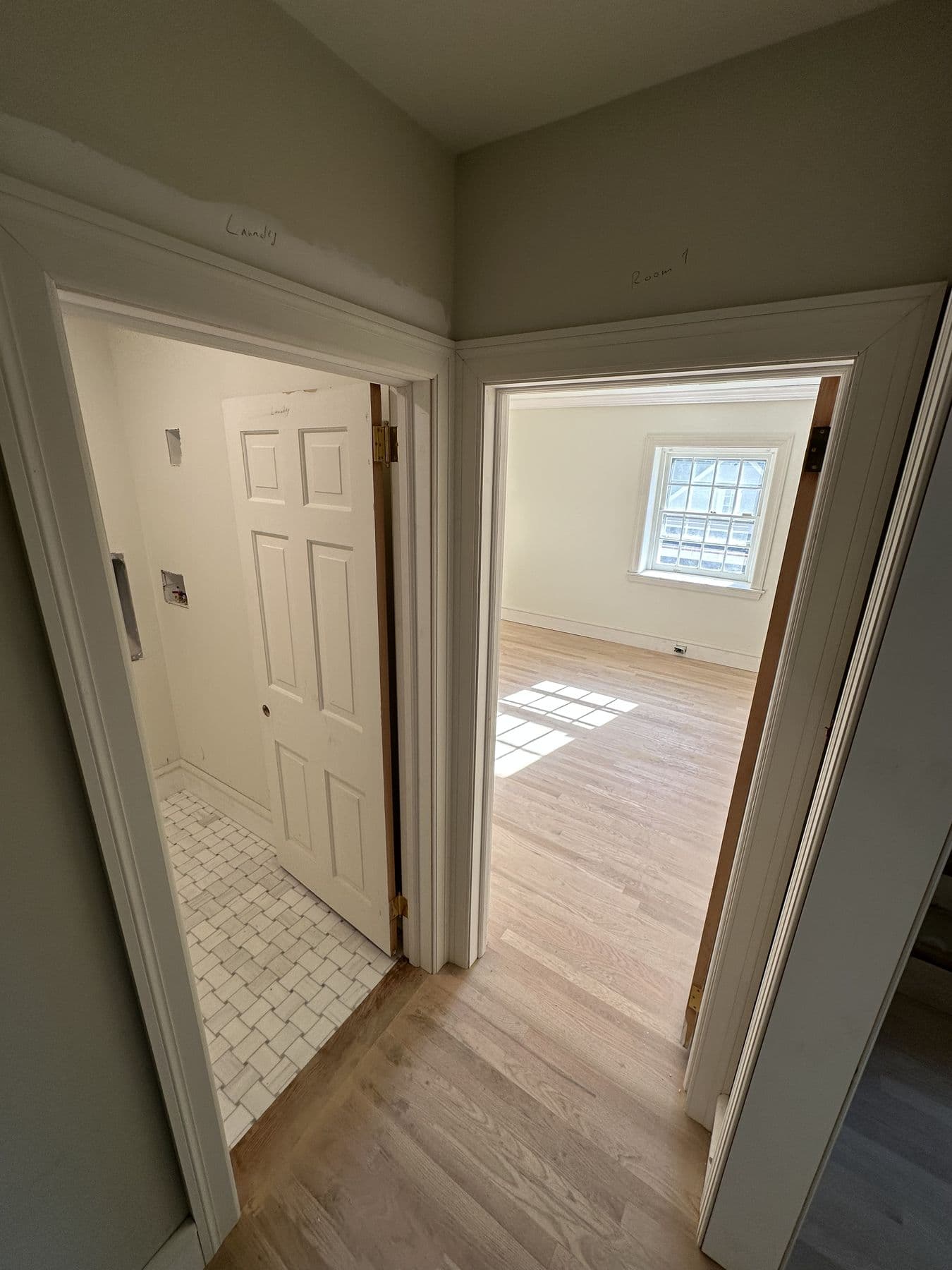 Doorway into a bathroom with new casing and baseboard