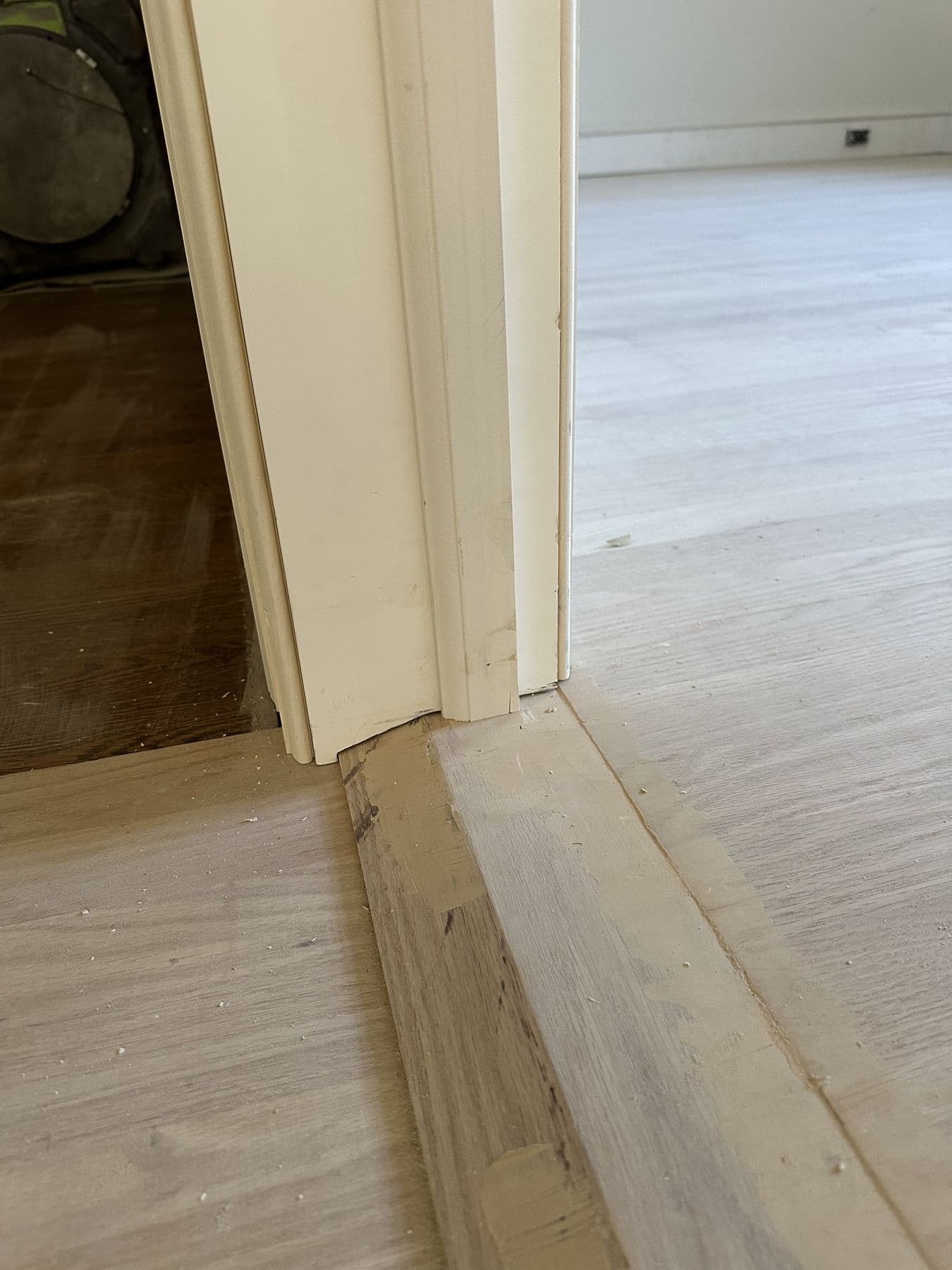 Threshold and door jamb where new oak flooring meets the old floor