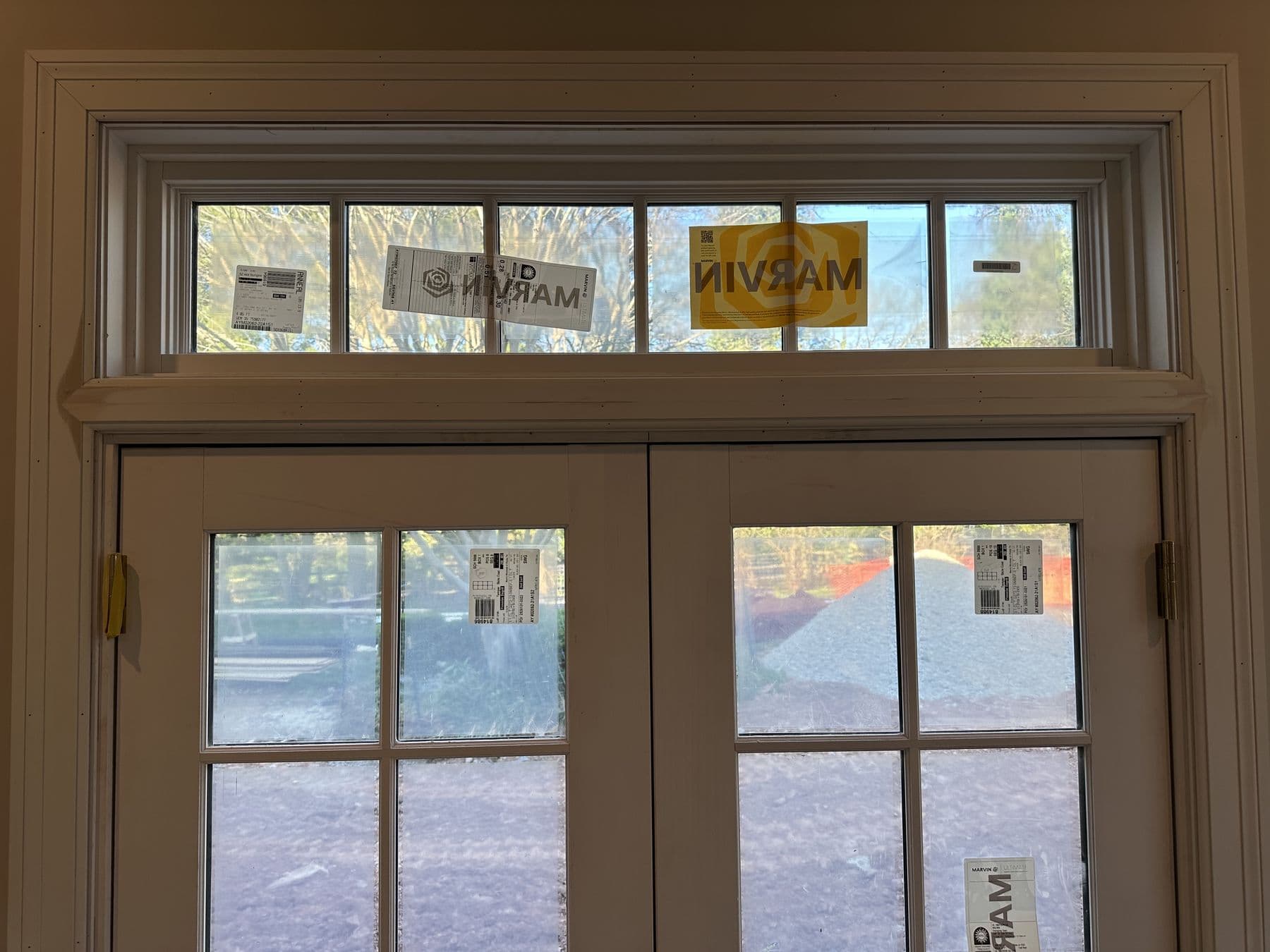 French doors with a transom above, trimmed in white