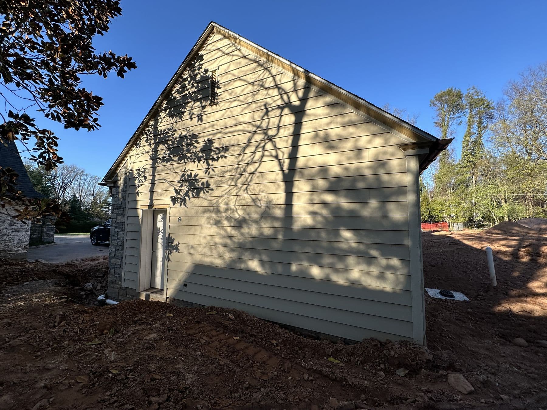 Exterior of the cottage in cream lap siding with white trim