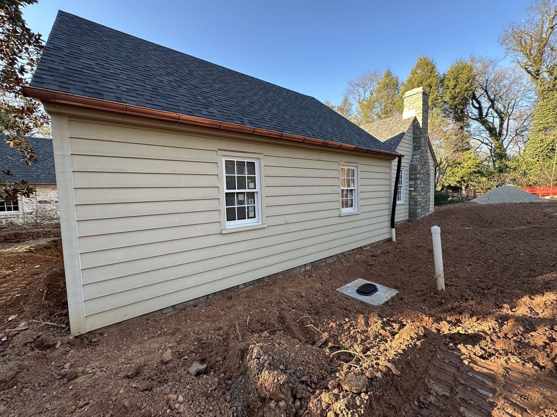 Side of the building in lap siding with new windows and a shingle roof